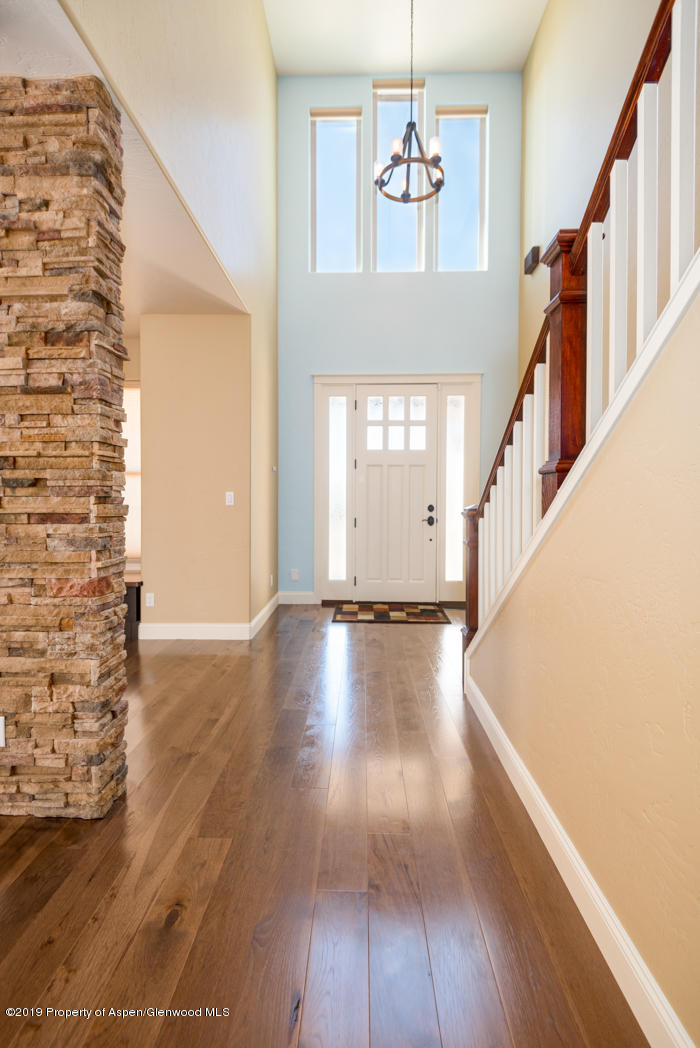 1317 East 17th Street Rifle, CO 81650 - Photo 5 of 57 a view of a hallway with wooden floor and staircase