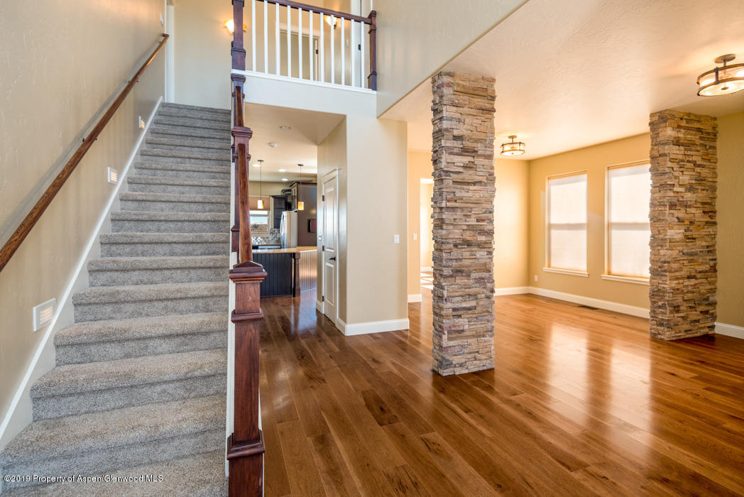 1317 East 17th Street Rifle, CO 81650 - Photo 7 of 57 a view of an entryway with wooden floor and staircase