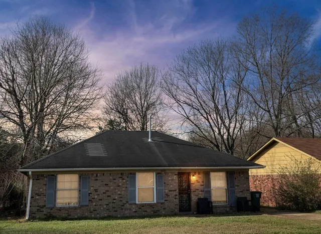 a front view of house with yard and green space