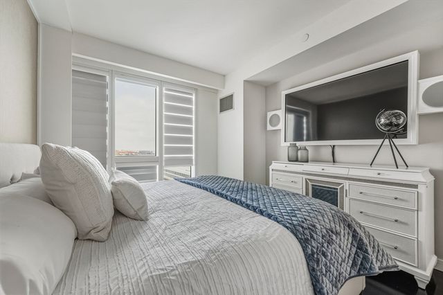 a living room with a bed and cabinets