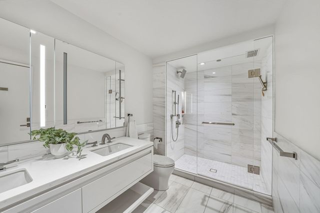 a bathroom with a shower and toilet