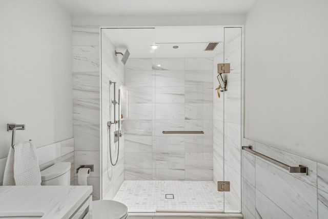 a bathroom with a tub a sink and mirror