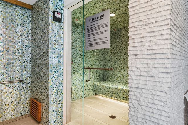 a dining room with furniture and a large window