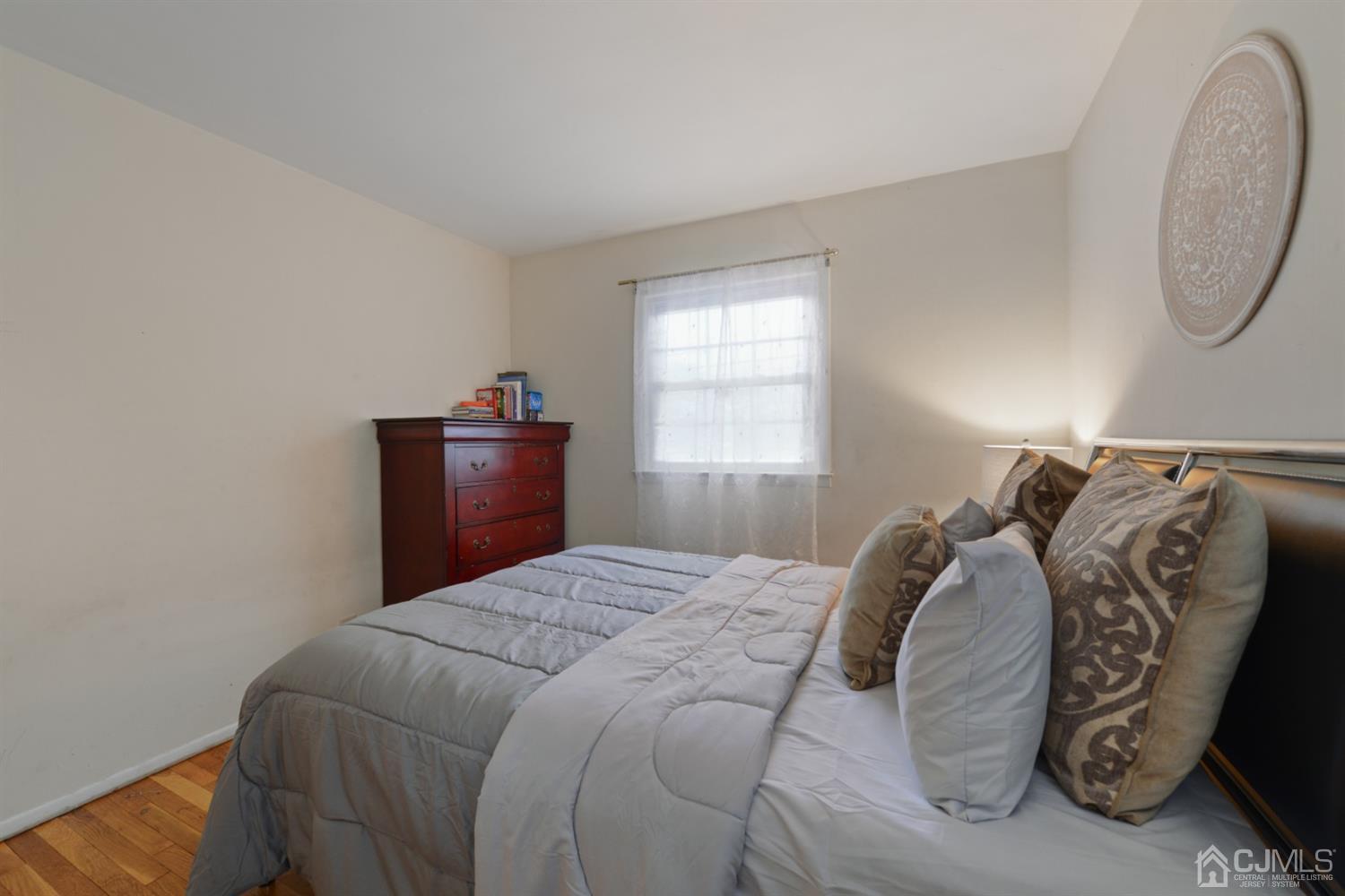 94 Vineyard Road Edison, NJ 08817 - Photo 22 of 30 a bedroom with a bed and a chandelier