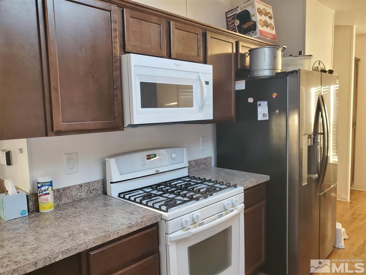 7610 Lytton Road Reno, NV 89506 - Photo 3 of 17 a kitchen with stainless steel appliances granite countertop a refrigerator and a stove