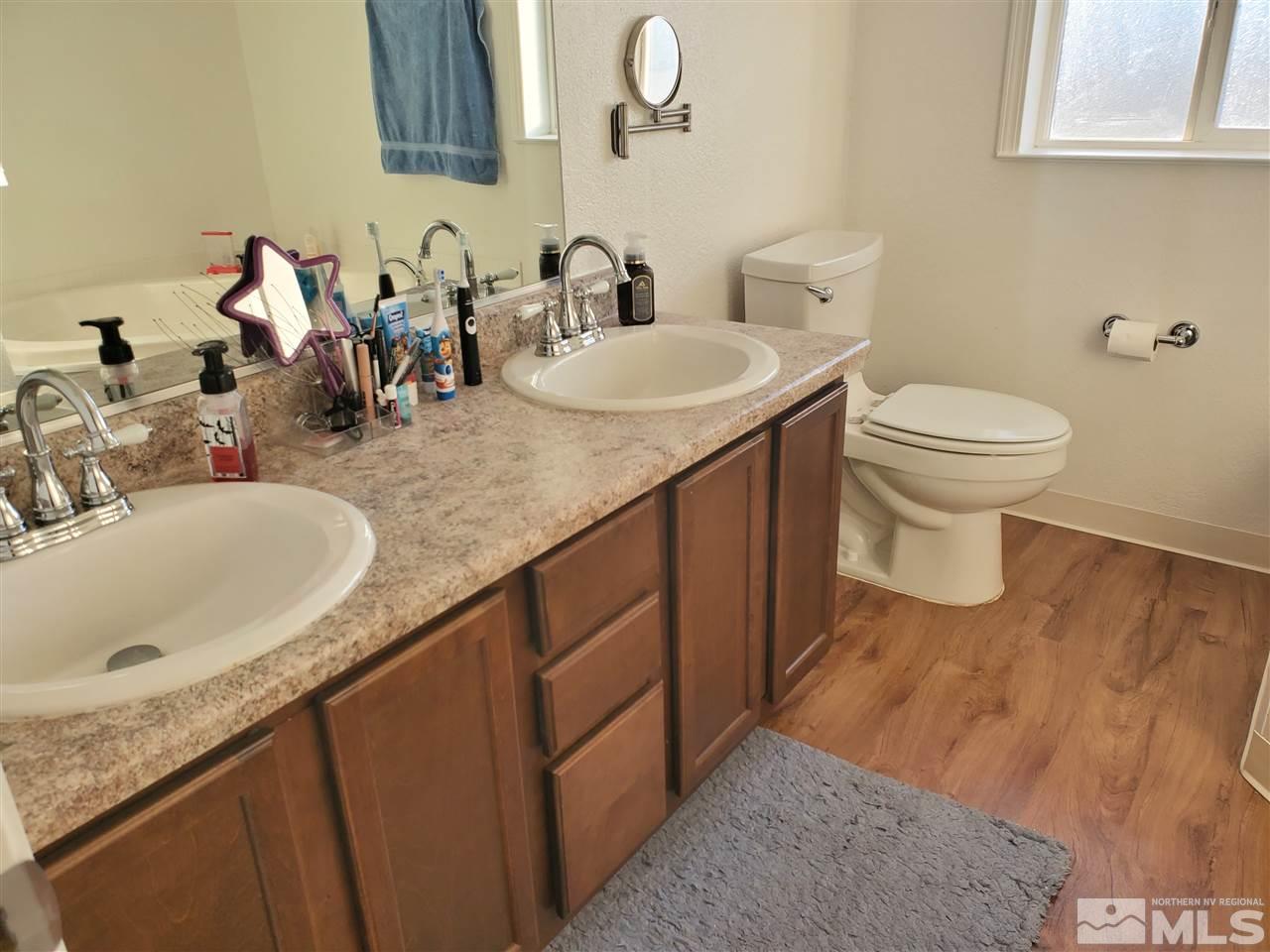 7610 Lytton Road Reno, NV 89506 - Photo 6 of 17 a bathroom with a granite countertop sink and a mirror