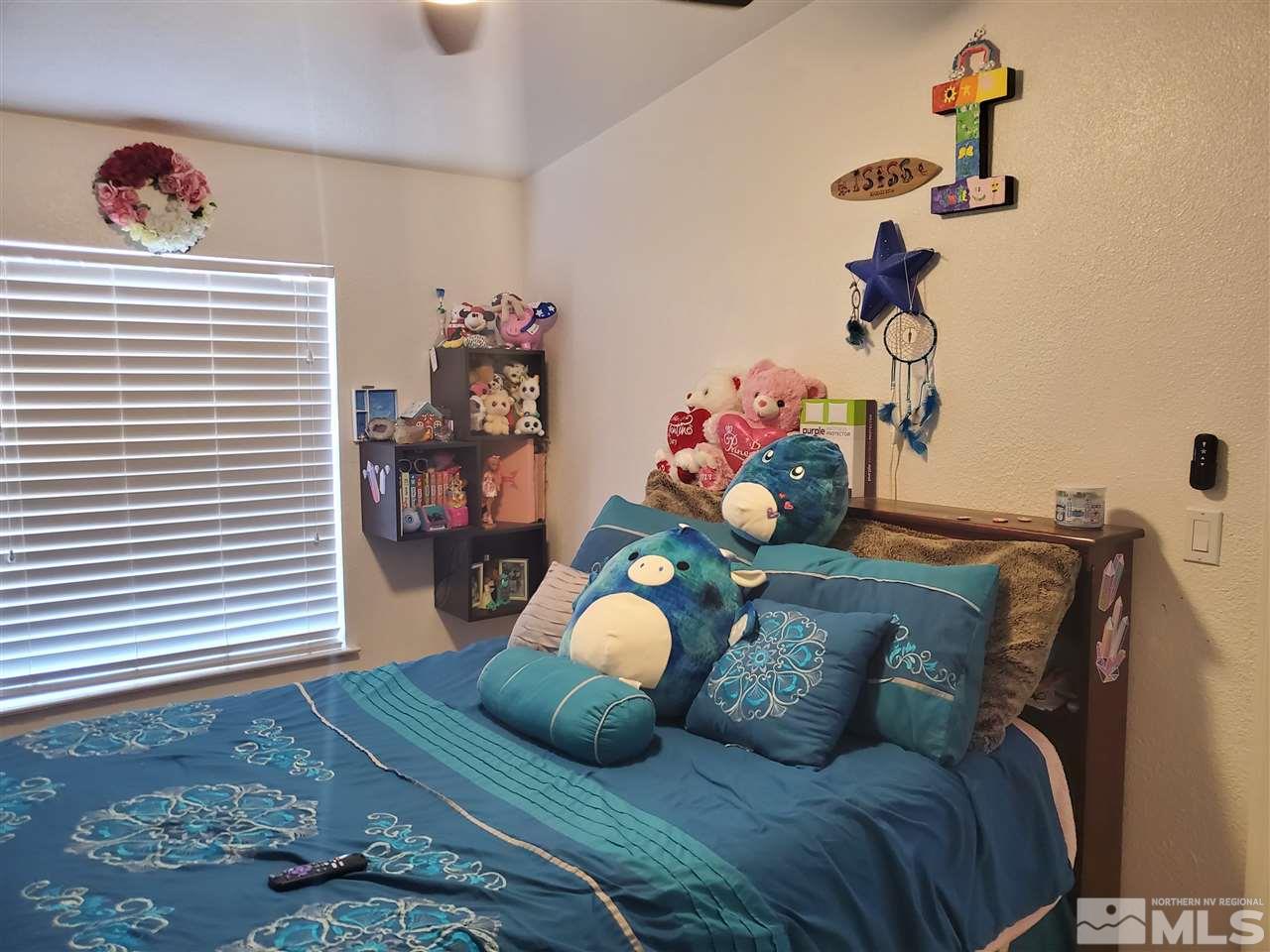 7610 Lytton Road Reno, NV 89506 - Photo 9 of 17 a bedroom with a bed and a chandelier