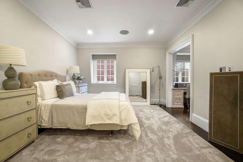 33 Beaver Place Boston, MA 02108 - Photo 14 of 22 a bedroom with a bed and a refrigerator