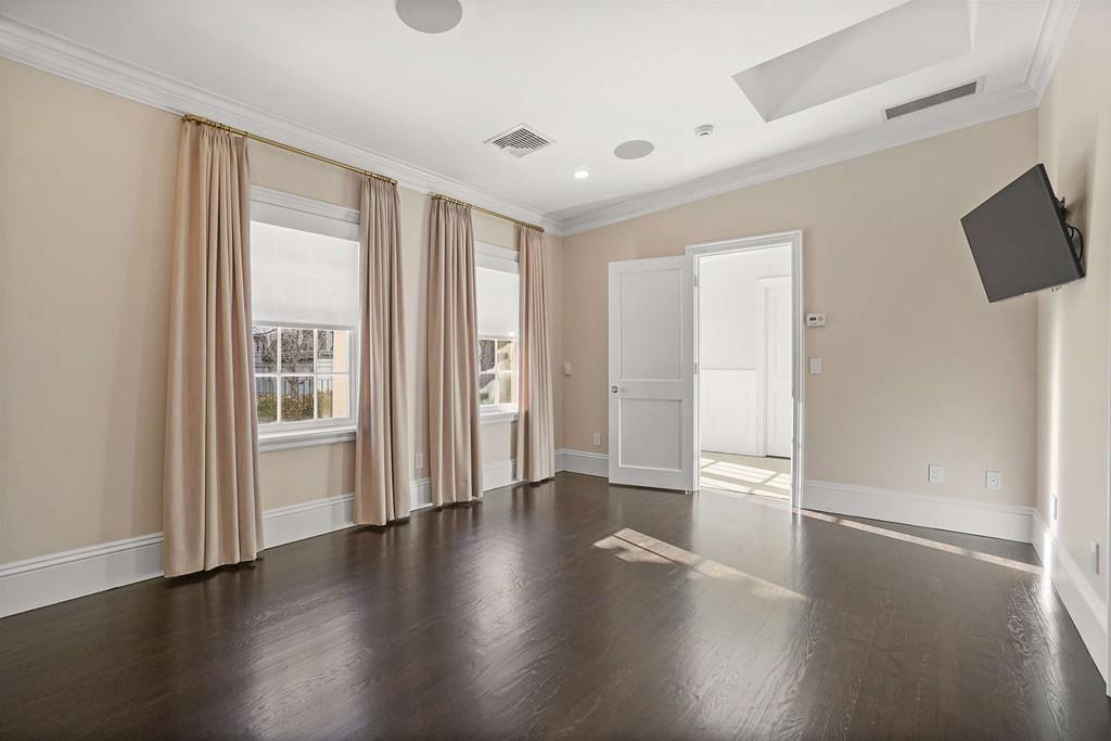 33 Beaver Place Boston, MA 02108 - Photo 18 of 22 an empty room with wooden floor and windows