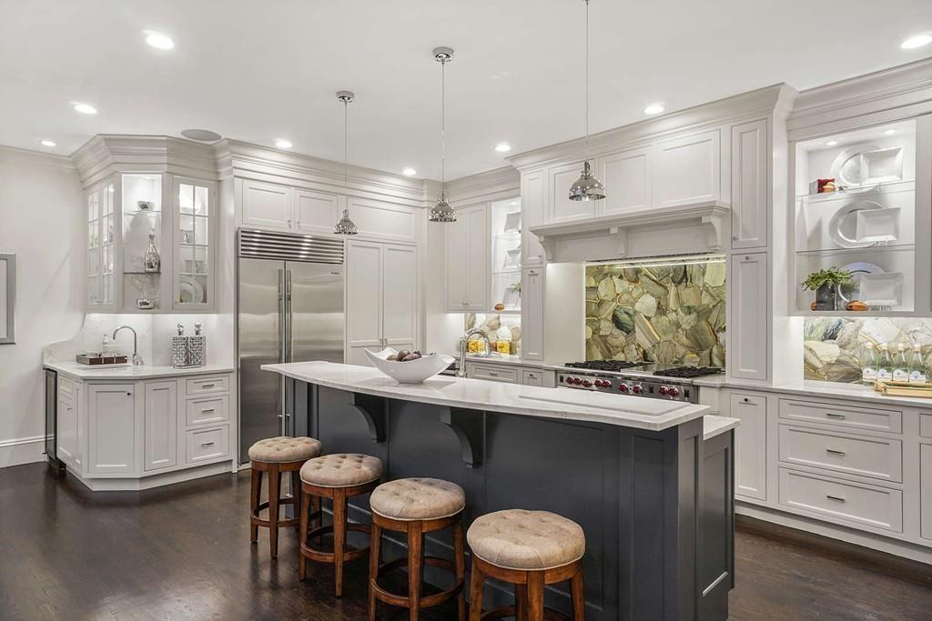 33 Beaver Place Boston, MA 02108 - Photo 7 of 22 a kitchen with stainless steel appliances a sink and a refrigerator