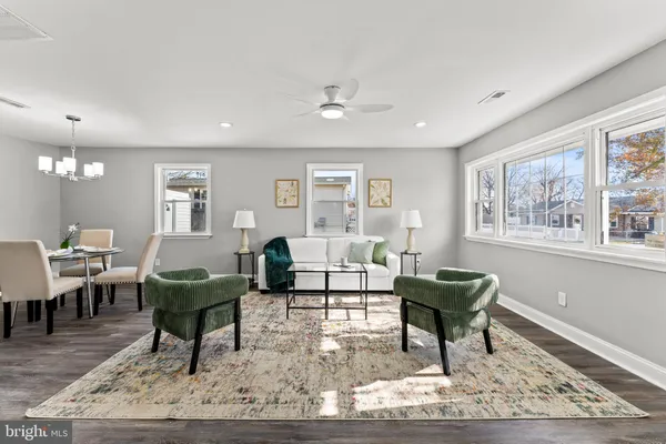 a living room with furniture a rug and a window