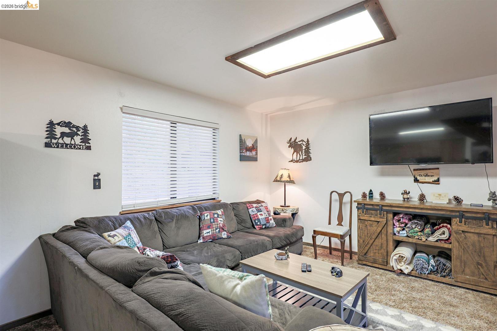 26600 Inyo Drive Cold Springs, CA 95335 - Photo 13 of 38 a living room with furniture and a flat screen tv
