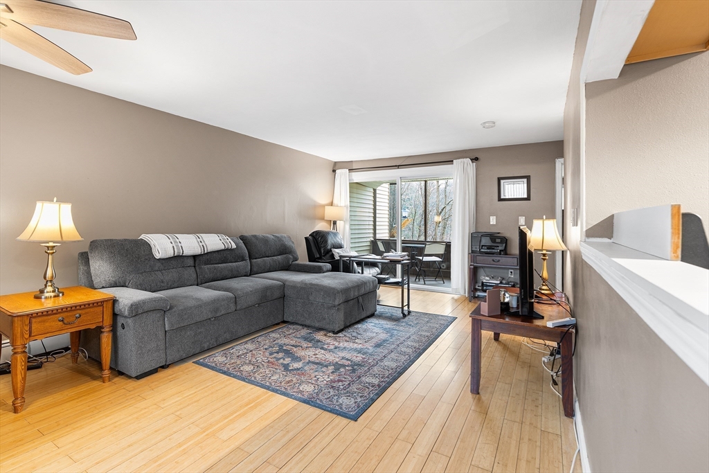 17 Powderhouse Court, Unit 17 Amesbury, MA 01913 - Photo 2 of 13 a living room with furniture and a wooden floor