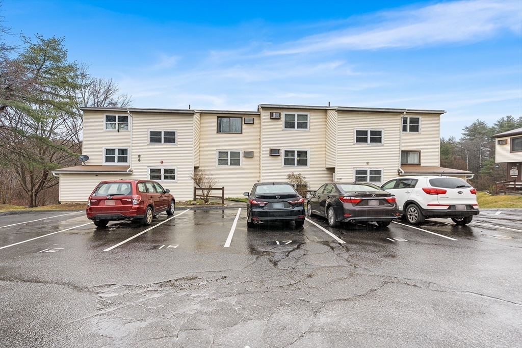17 Powderhouse Court, Unit 17 Amesbury, MA 01913 - Photo 3 of 13 a car parked in front of a white house