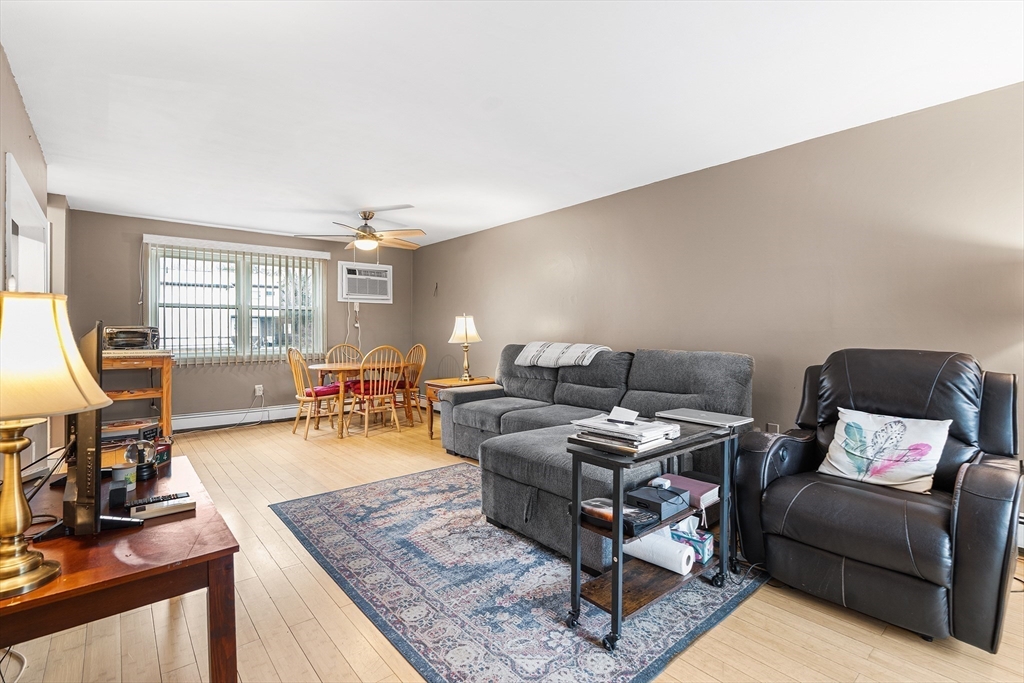 17 Powderhouse Court, Unit 17 Amesbury, MA 01913 - Photo 5 of 13 a living room with furniture and a wooden floor