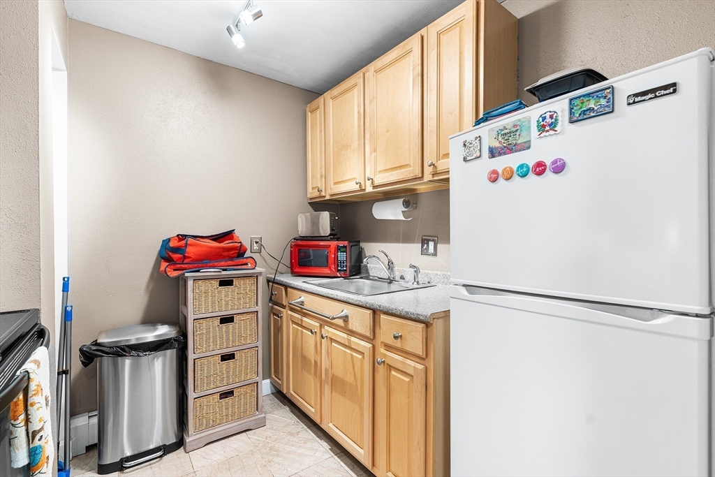17 Powderhouse Court, Unit 17 Amesbury, MA 01913 - Photo 6 of 13 a utility room with cabinets washer and dryer