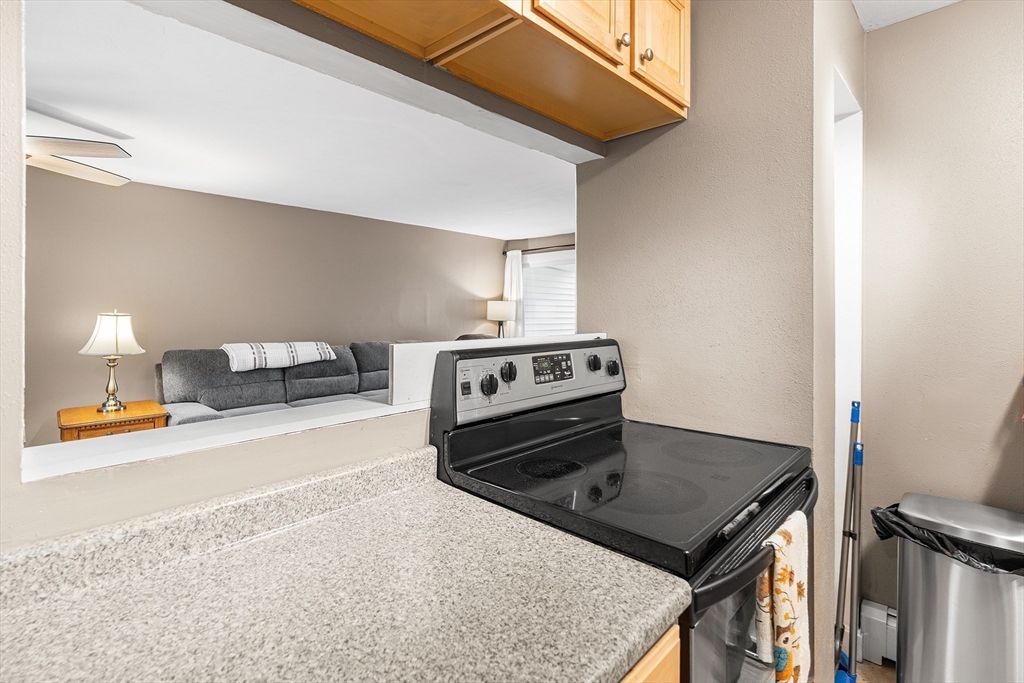 17 Powderhouse Court, Unit 17 Amesbury, MA 01913 - Photo 7 of 13 a kitchen with a stove a sink and a refrigerator