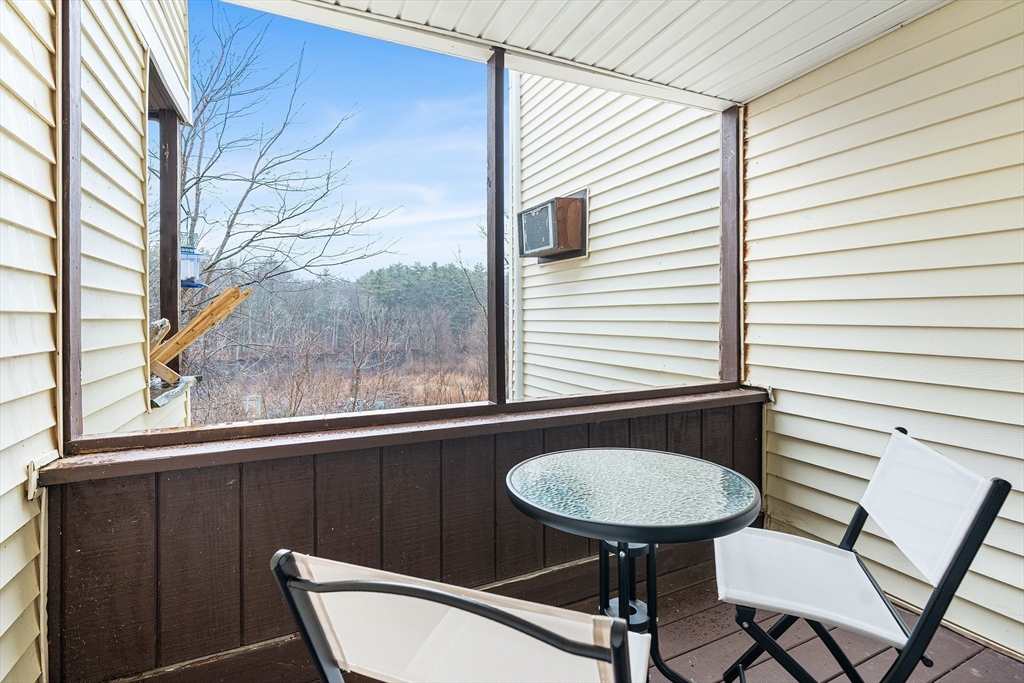 17 Powderhouse Court, Unit 17 Amesbury, MA 01913 - Photo 8 of 13 a view of a chair and table in the balcony