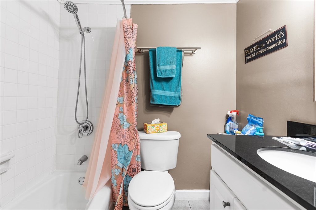 17 Powderhouse Court, Unit 17 Amesbury, MA 01913 - Photo 9 of 13 a bathroom with a toilet sink and mirror