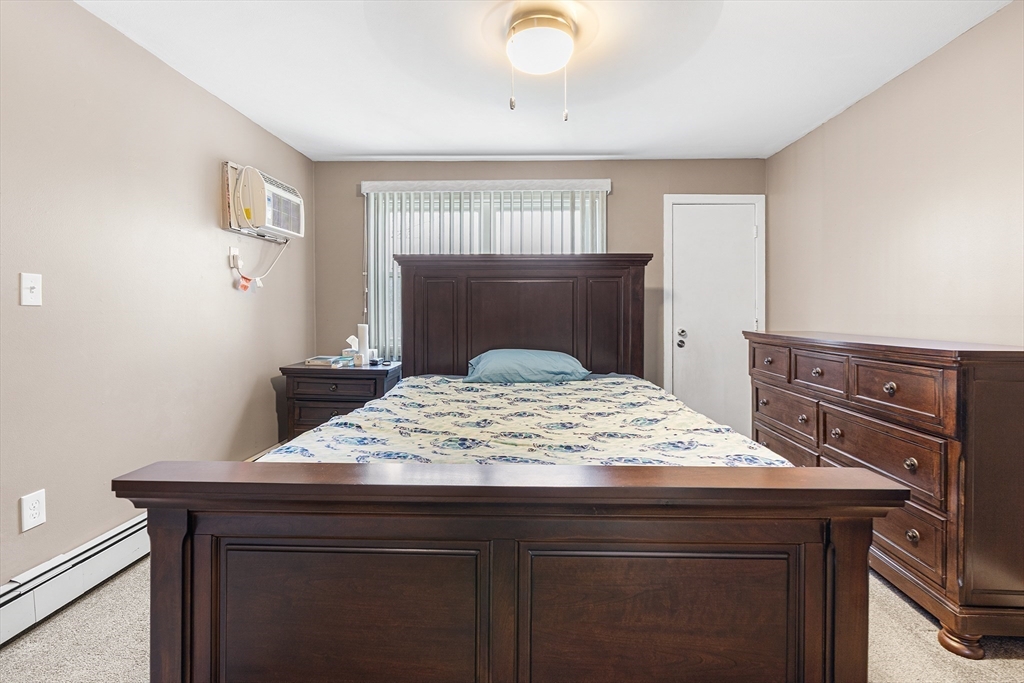 17 Powderhouse Court, Unit 17 Amesbury, MA 01913 - Photo 10 of 13 a bedroom with a dresser and a window
