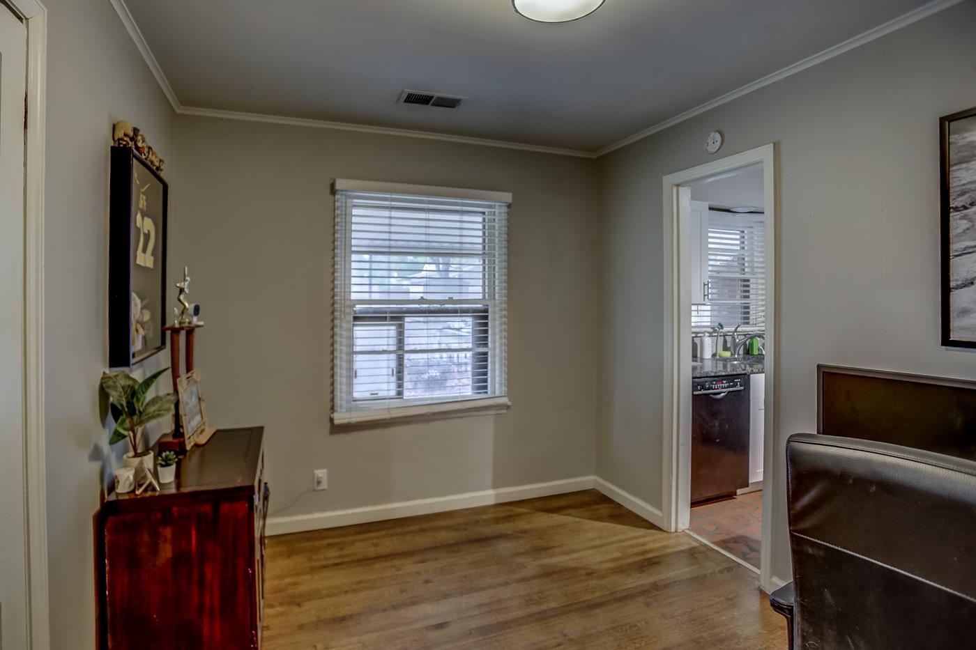 4464 Helene Road Memphis, TN 38117 - Photo 14 of 27 a view of an empty room with wooden floor and a window