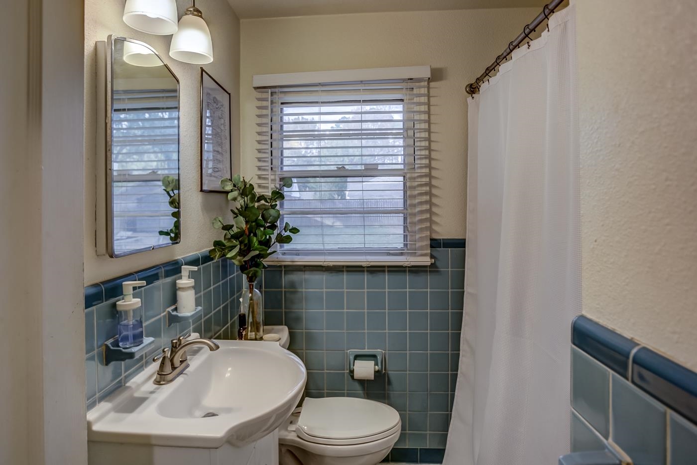 4464 Helene Road Memphis, TN 38117 - Photo 17 of 27 a bathroom with a sink a toilet and mirror