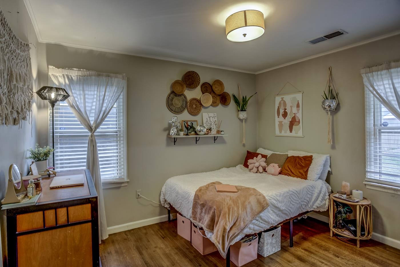 4464 Helene Road Memphis, TN 38117 - Photo 21 of 27 a bedroom with a bed and a lamp on dresser with wooden floor