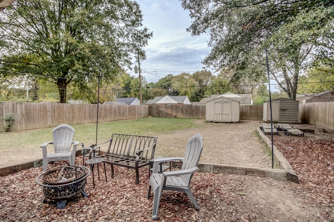 4464 Helene Road Memphis, TN 38117 - Photo 24 of 27 a view of a patio with a dining table and chairs with a fire pit