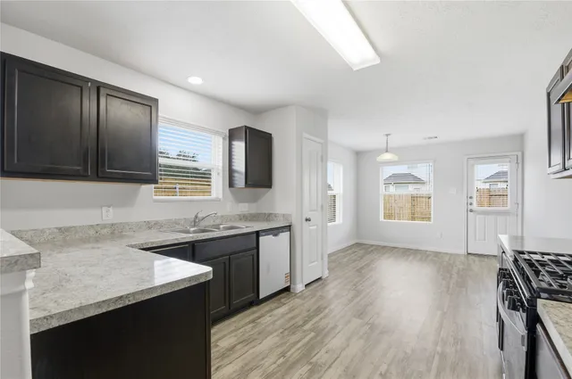 a kitchen with a sink stove and microwave