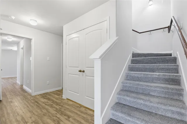 a view of an entryway with wooden floor