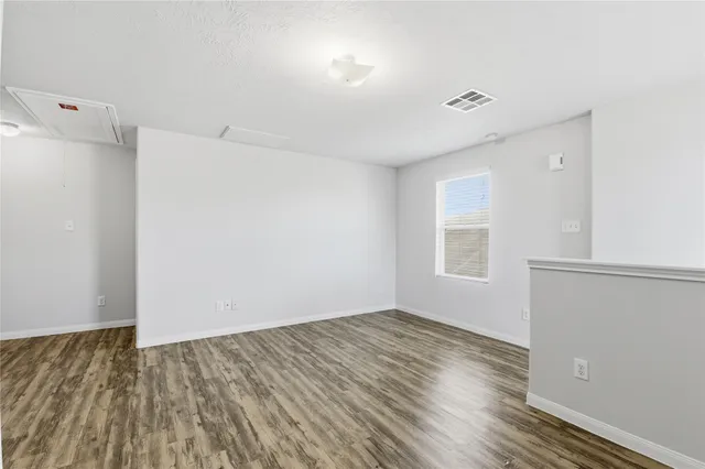 a view of a room with wooden floor and window