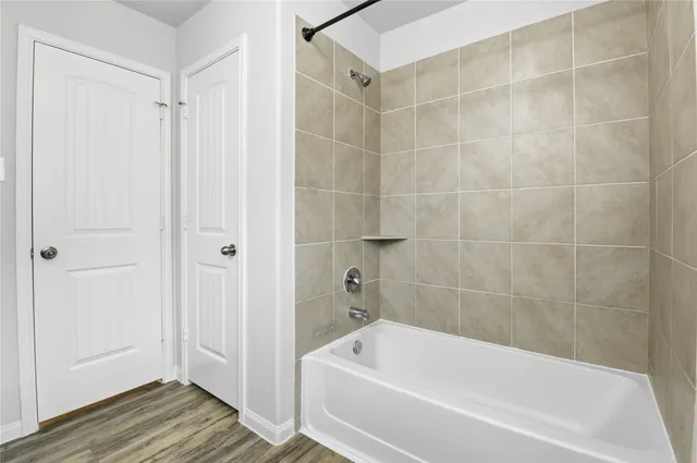 a bathroom with a bathtub and a shower