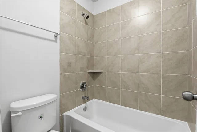 a bathroom with a bathtub and toilet