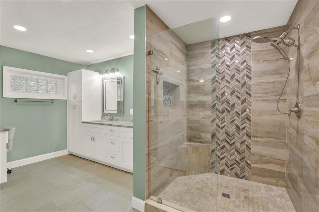 7487 River Country Drive Weeki Wachee, FL 34607 - Photo 29 of 53 a bathroom with a shower and a mirror