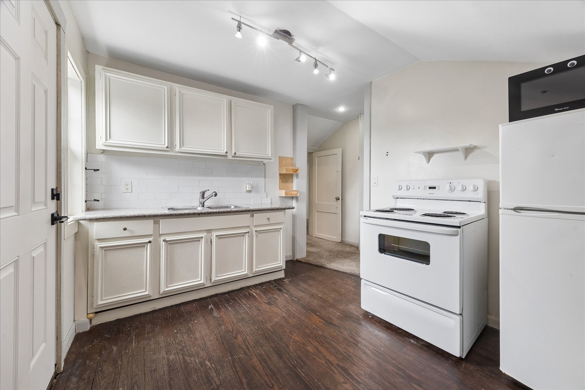 4412 Rusk Street Houston, TX 77023 - Photo 25 of 44 Second floor living space kitchen features granite counters, refrigerator, electric range, abundant storage & hardwood floors.