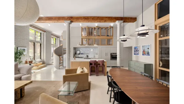 a living room with fireplace furniture and a chandelier