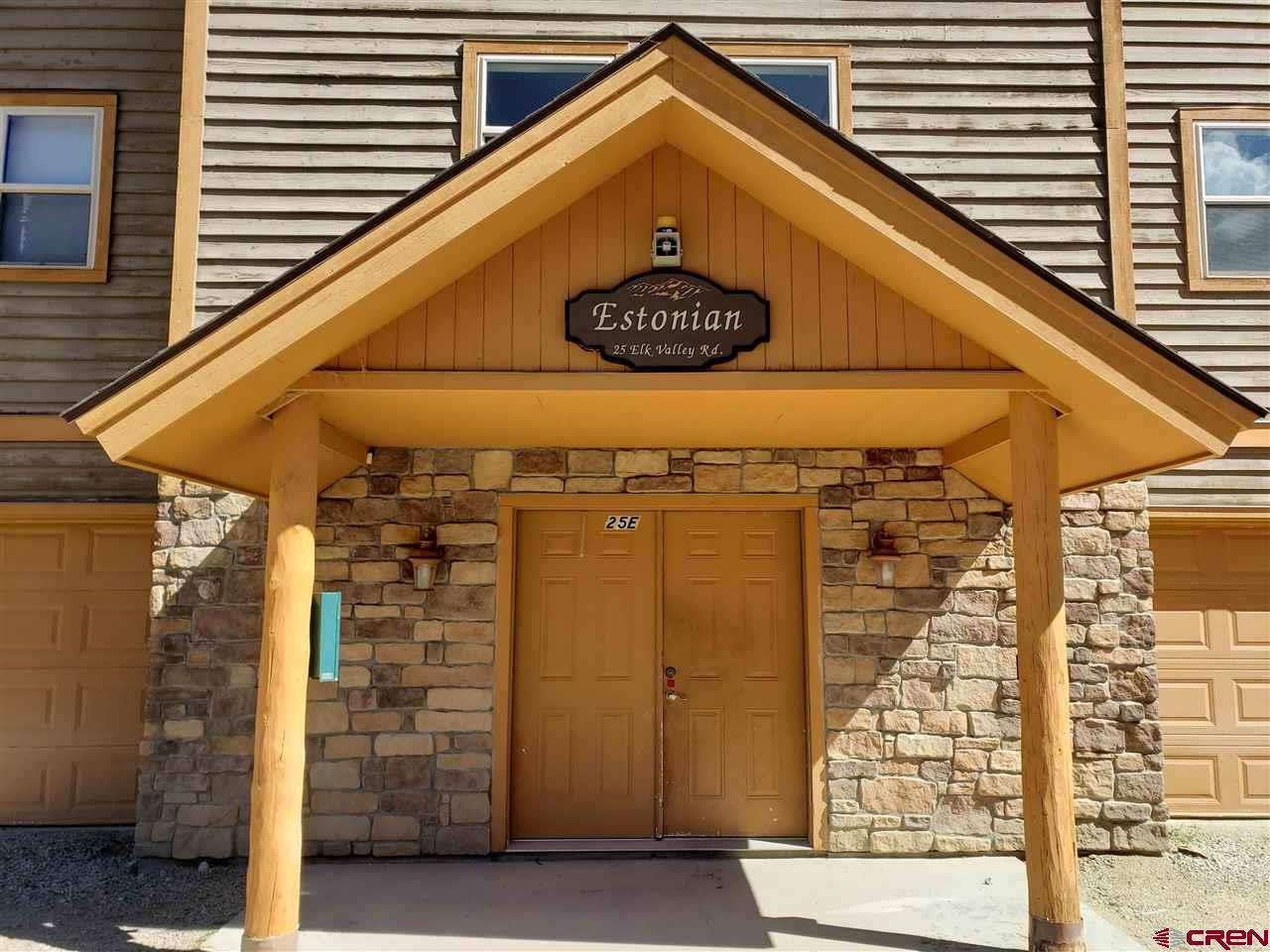 25 Elk Valley Road, Unit 102 Crested Butte, CO 81224 - Photo 2 of 12 a view of a wooden door with a small yard