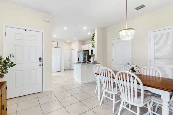 a kitchen with stainless steel appliances granite countertop a refrigerator a sink a stove top oven and cabinets
