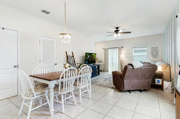 a dining room with furniture and chandelier