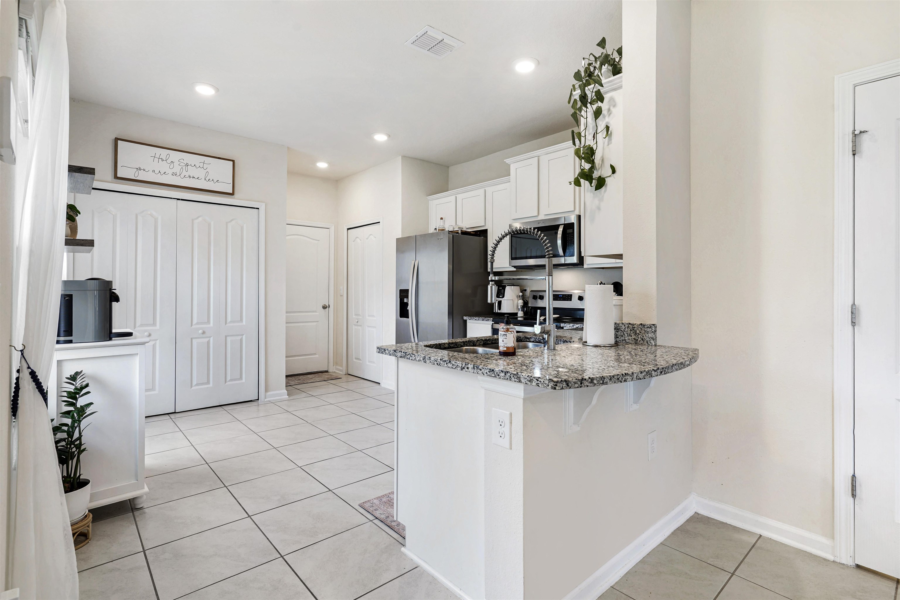 135 Pomona Way St. Augustine, FL 32095 - Photo 13 of 33 a kitchen with kitchen island granite countertop a sink cabinets and refrigerator