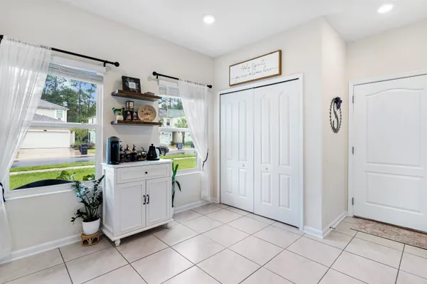 a kitchen with kitchen island granite countertop a sink cabinets and refrigerator