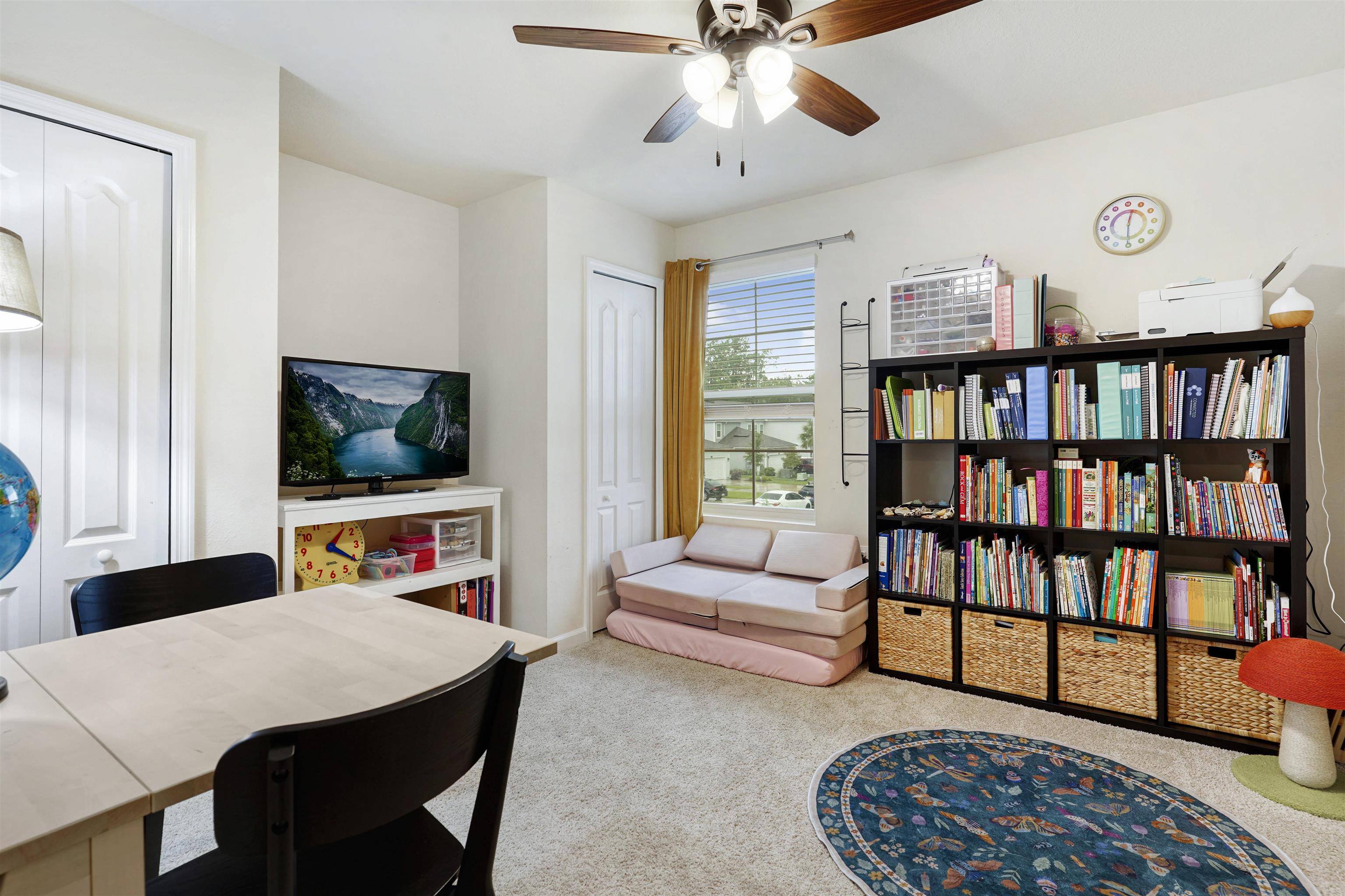 135 Pomona Way St. Augustine, FL 32095 - Photo 23 of 33 a living room with furniture and a book shelf