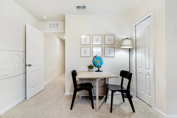 a living room with furniture and a book shelf