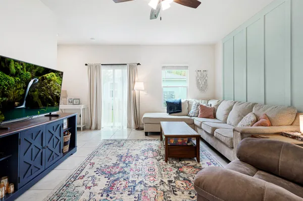 a living room with furniture and a flat screen tv