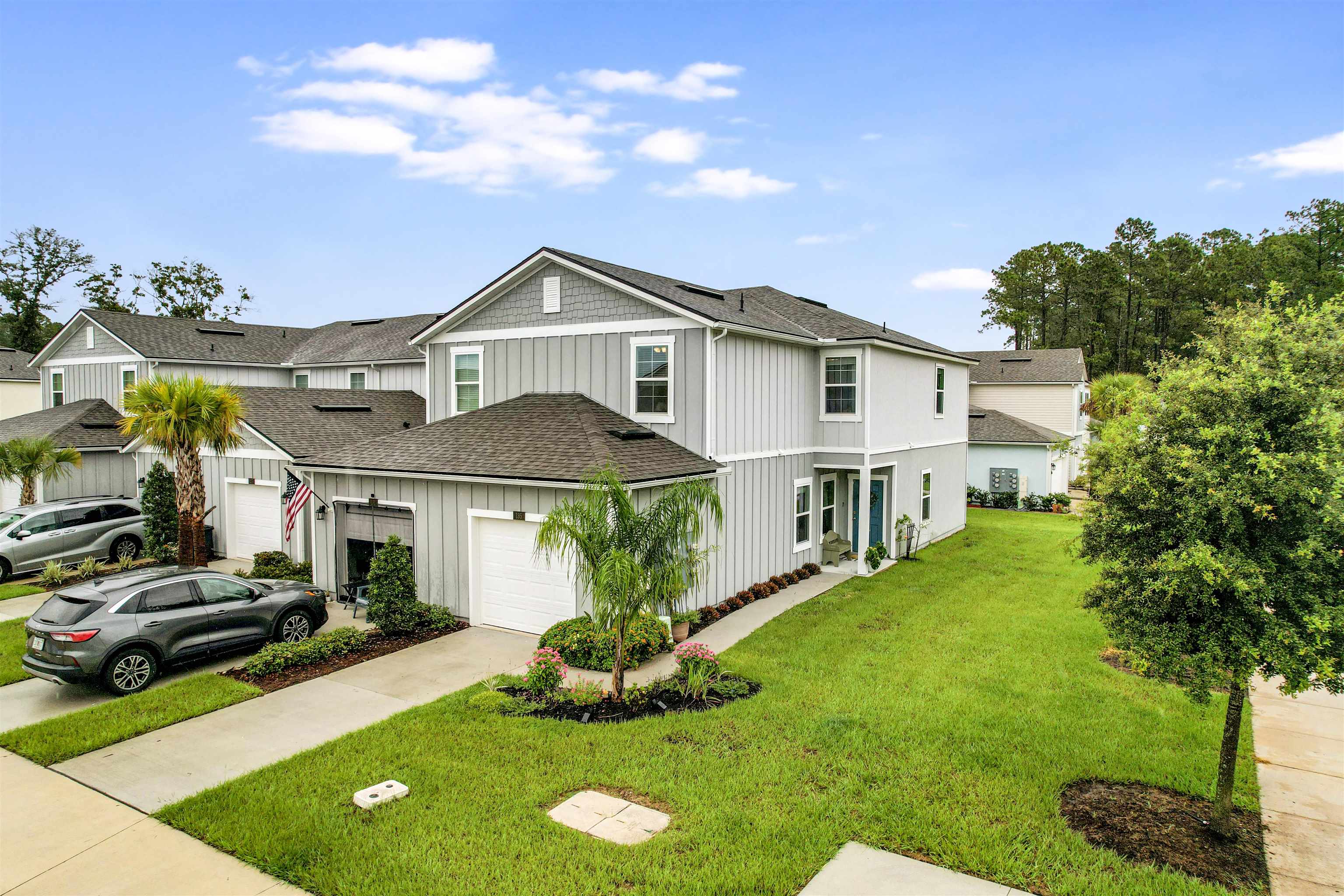 135 Pomona Way St. Augustine, FL 32095 - Photo 6 of 33 a front view of a house with a yard table and chairs