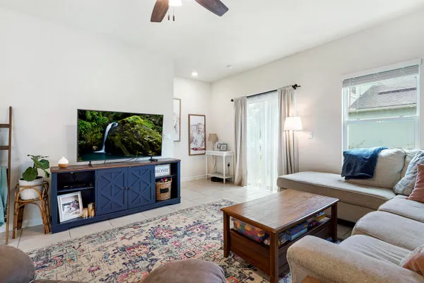 a living room with furniture a window and a flat screen tv