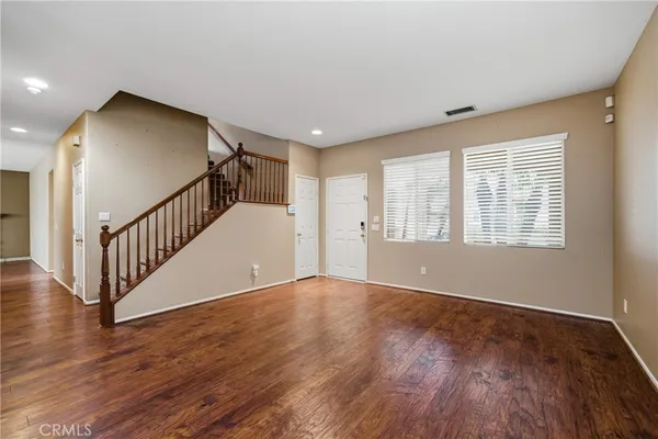 a kitchen with stainless steel appliances a stove cabinets and wooden floor