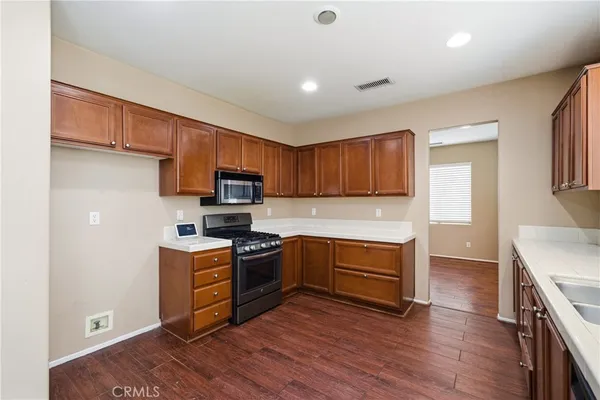 an empty room with windows and fireplace