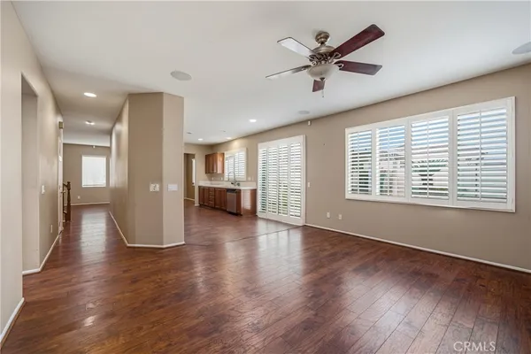 an empty room with a ceiling fan and a window