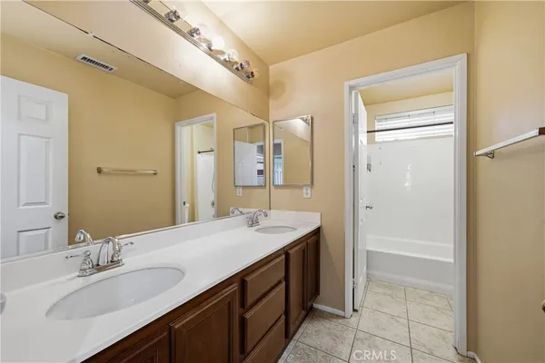 an empty room with ceiling fan and window